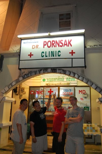 five men stand at the entrance of a clinic