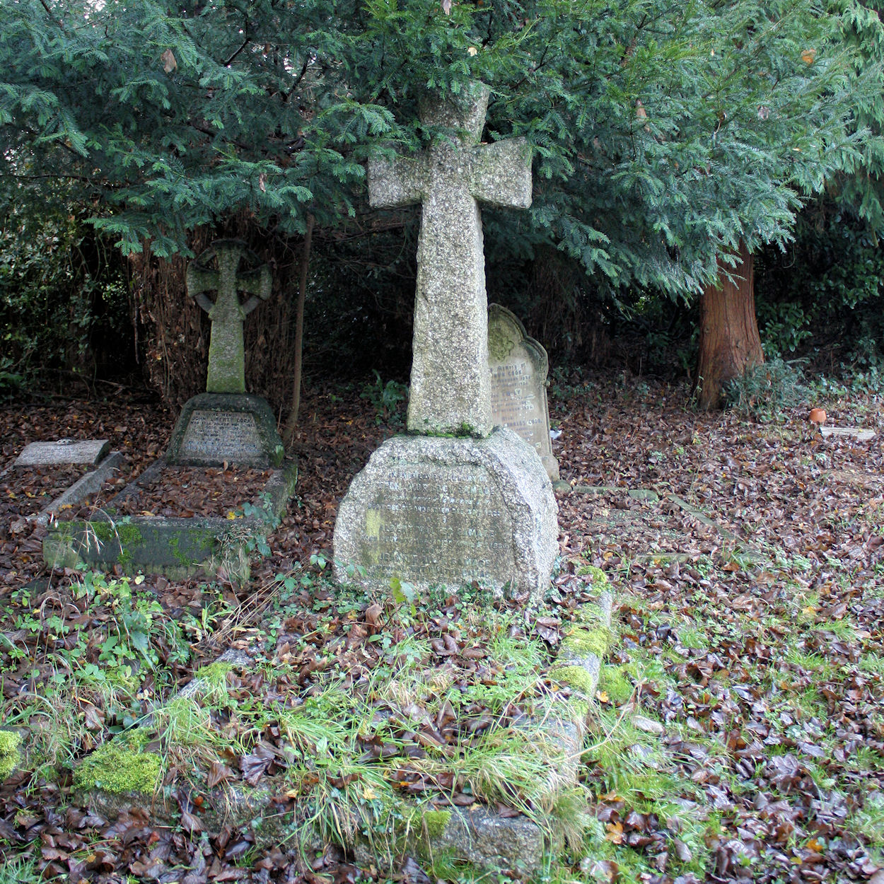 a graveyard has two headstones, one of which is shaped like an owl