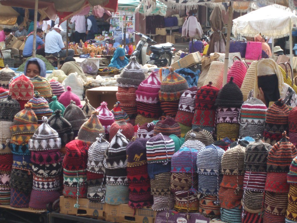 lots of knitted items at an outdoor market