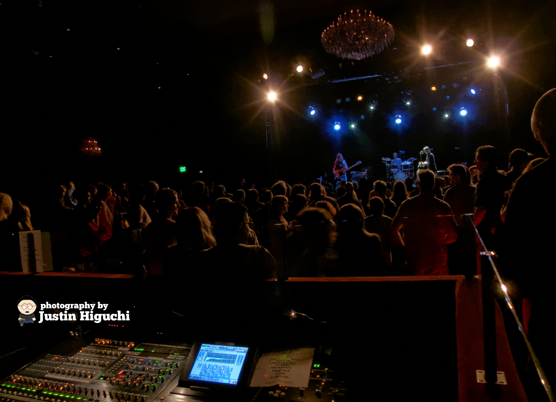 a huge group of people that are standing in front of a mixing table