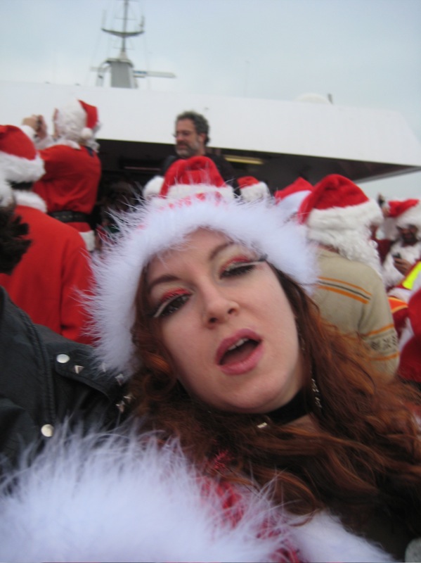 a woman in a santa hat with white fur on it