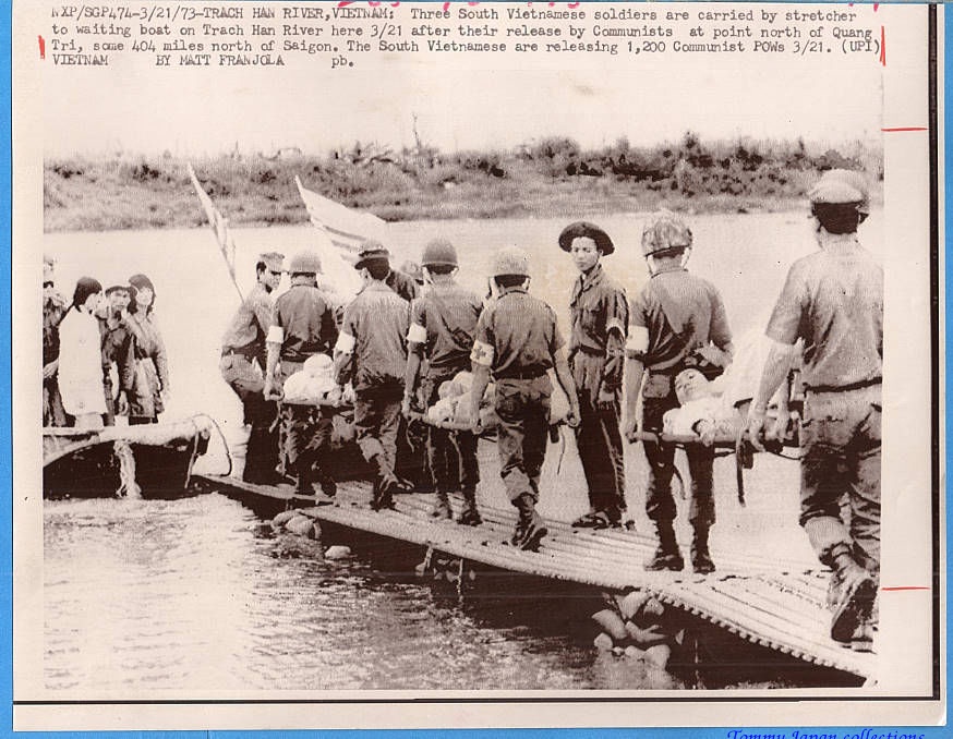 soldiers crossing the water in front of a small boat