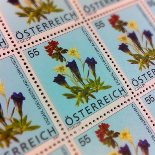 some different flowers that are on a postage stamp