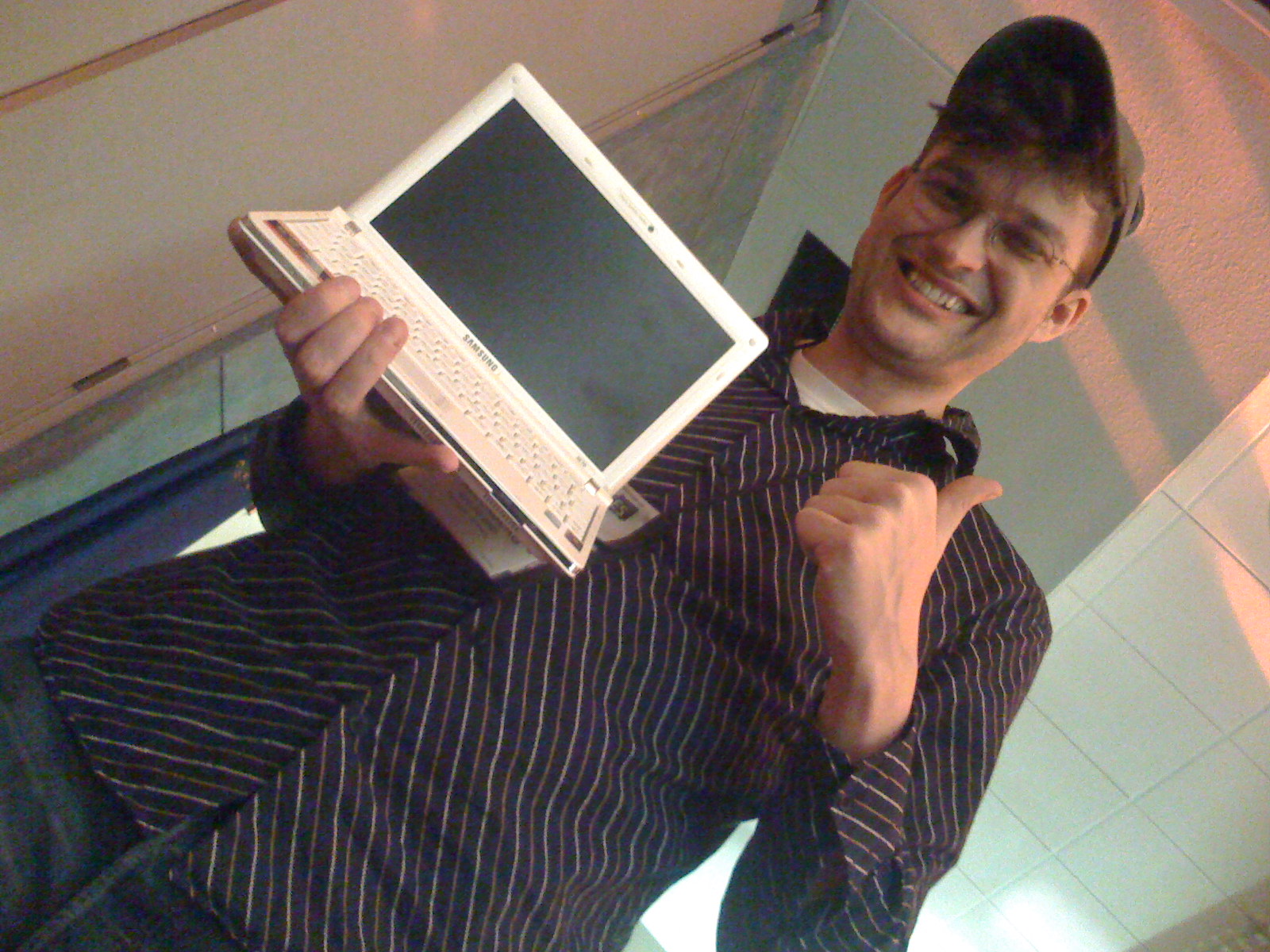 a young man holding onto an old electronic device