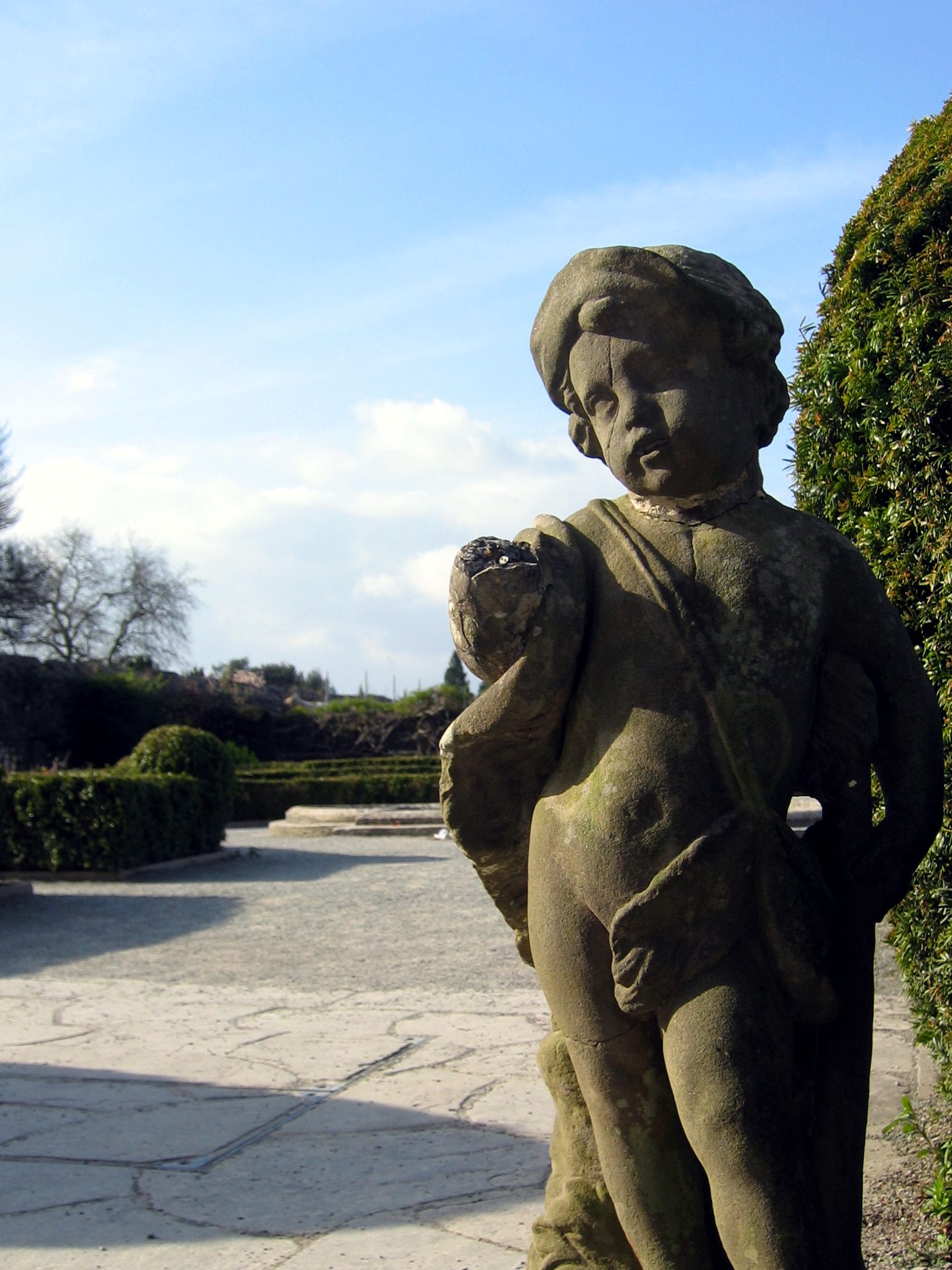 a stone statue that has a baby holding a cat