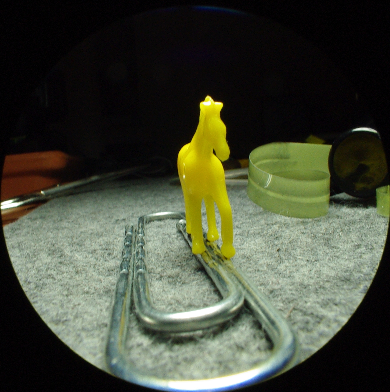 yellow plastic figures next to sunglasses on a round table