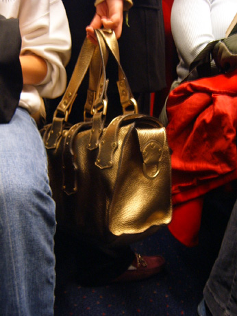 people's legs, bags and shoes are on the floor