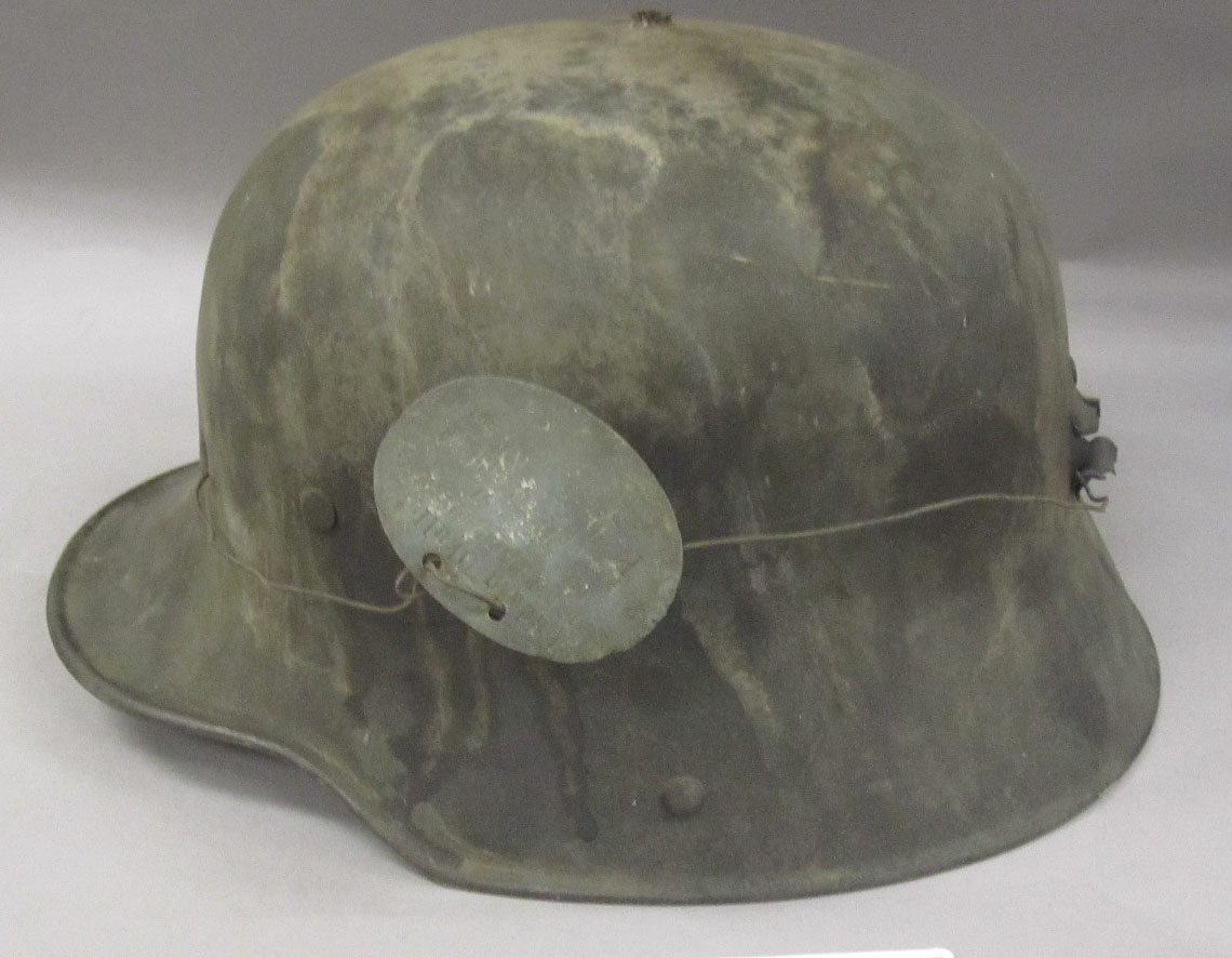 an army helmet has a metal buckle