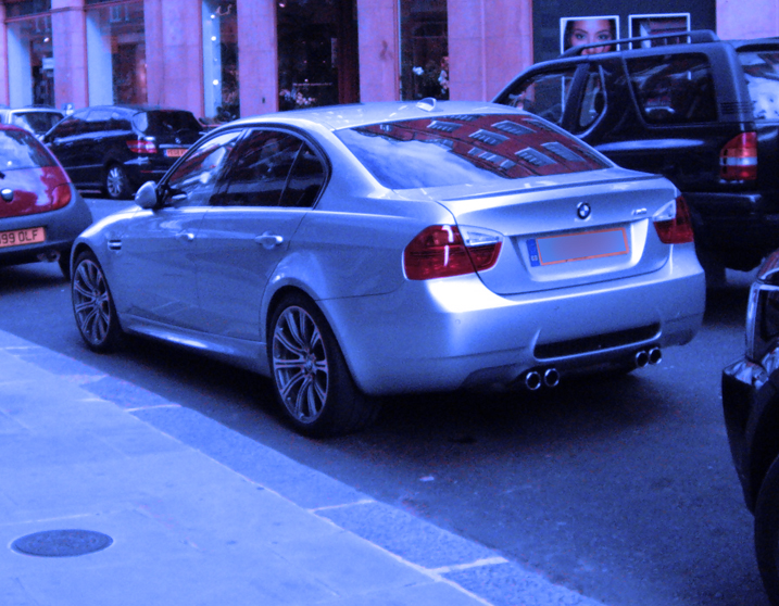 a few cars parked by a building in the evening