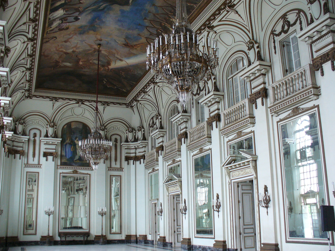 a fancy room filled with chandeliers and fancy mirrors