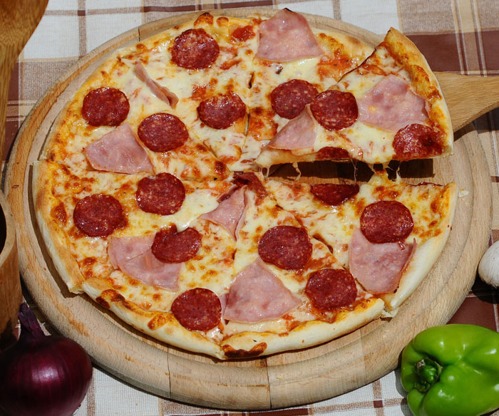 a pizza that is on a board on a table