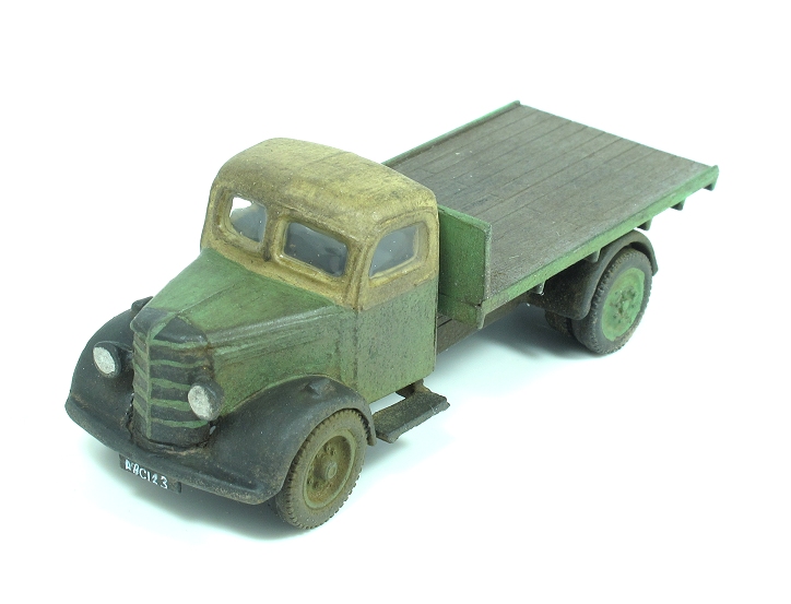 a plastic toy truck with a wooden trailer