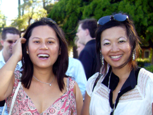 two ladies pose for the camera at an event