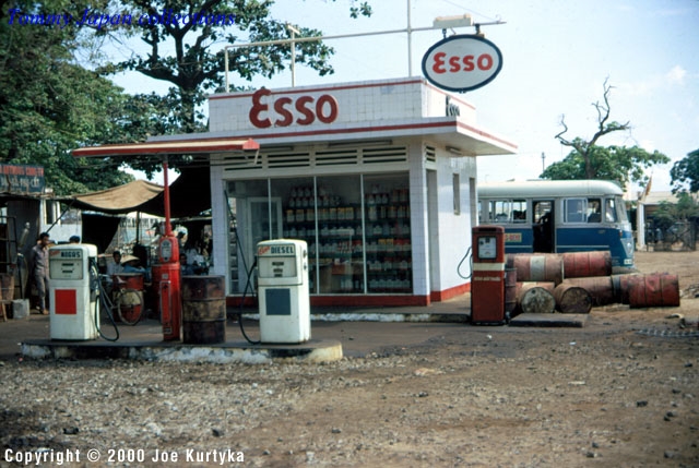 an old gas station with old cars and gas pumps