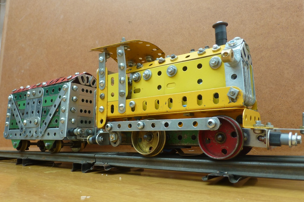 an elaborate and decorative toy train sits on the track
