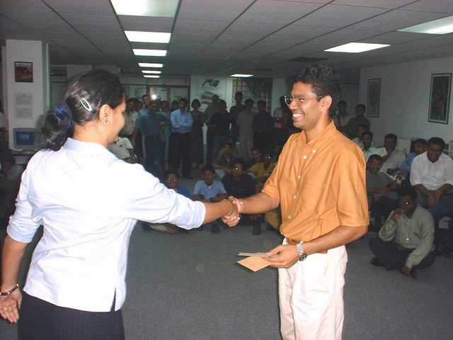 two people standing in an office shaking hands