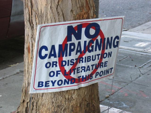 no campaign sign on a tree on the side of the road