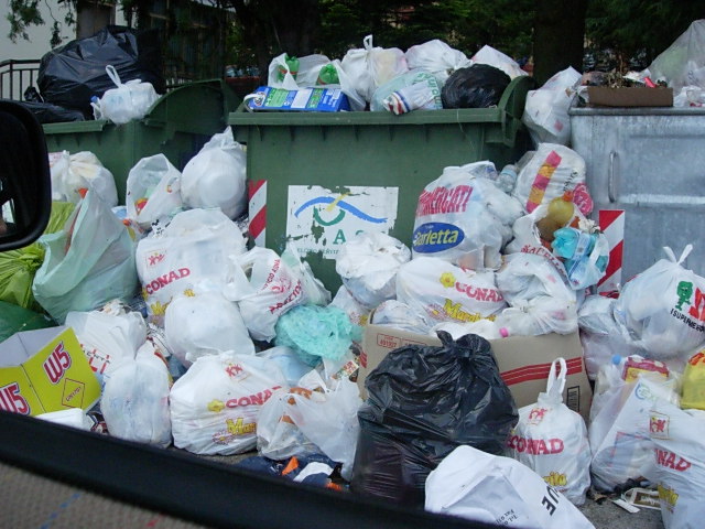 a truck full of plastic trash bags and bins