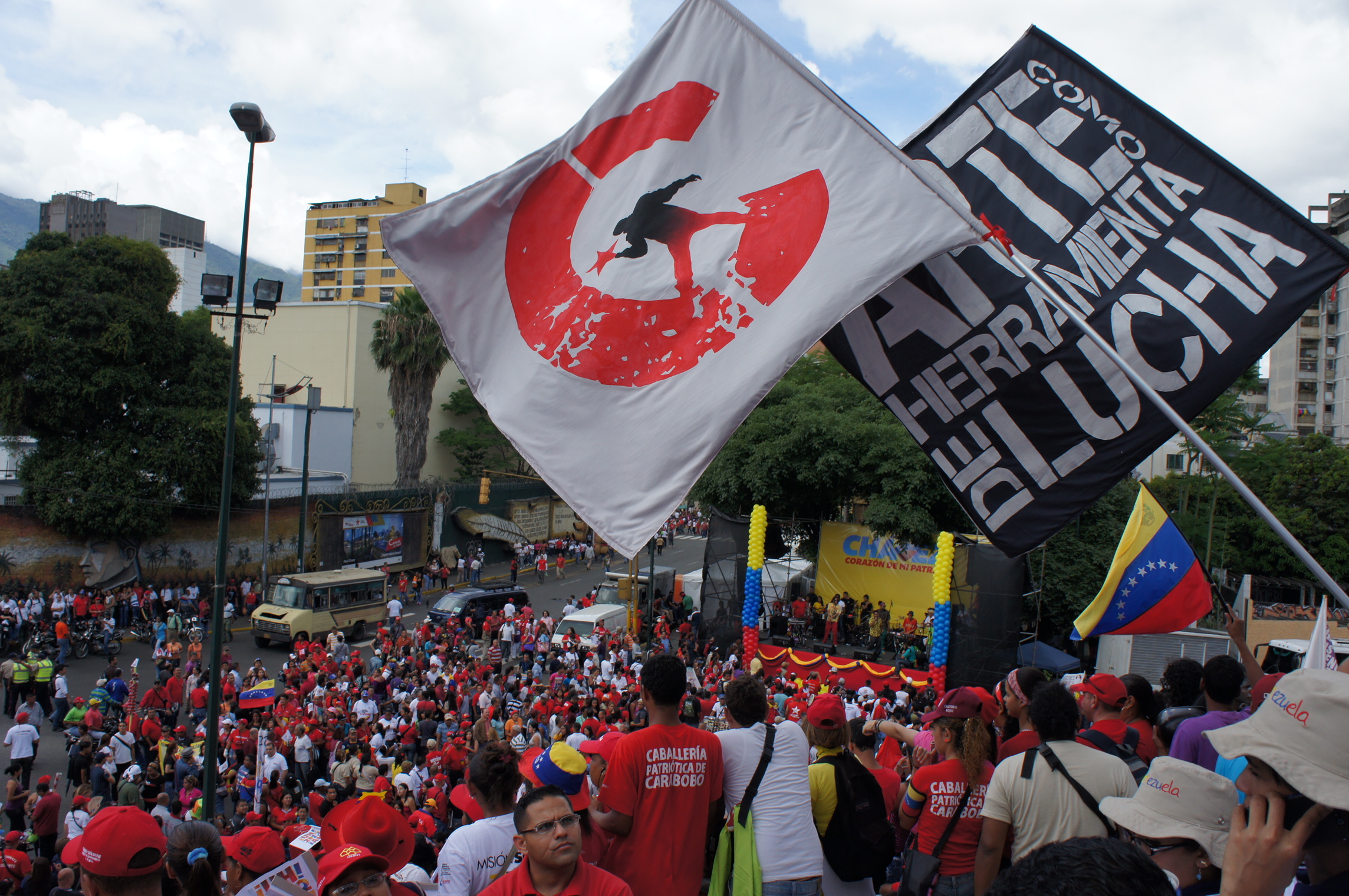 several people are holding a flag and a sign