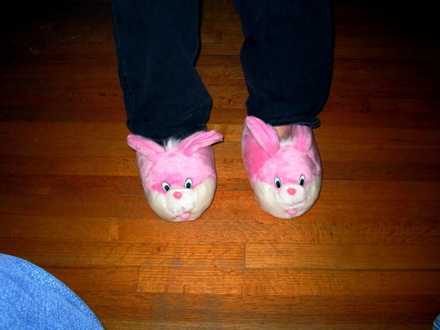 a pair of pink rabbits slippers are on someones feet