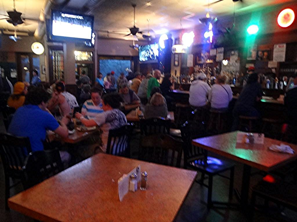 a crowded restaurant with patrons sitting at tables