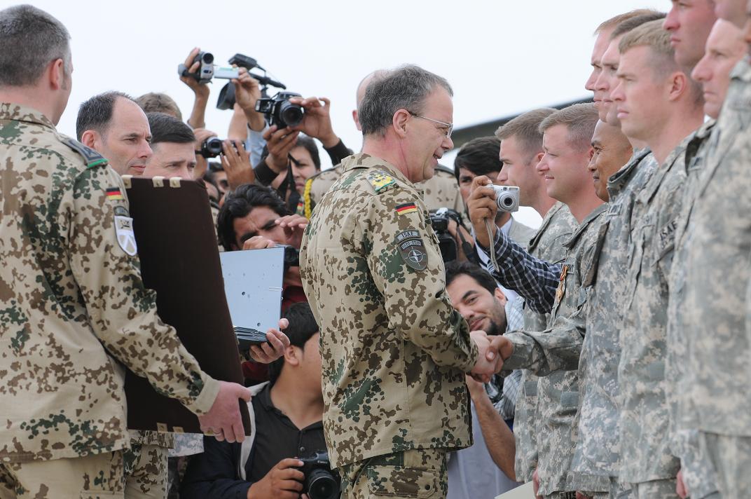 there is an army man giving a sign to a woman