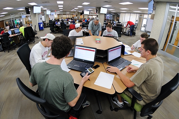 a room full of students working on their laptops