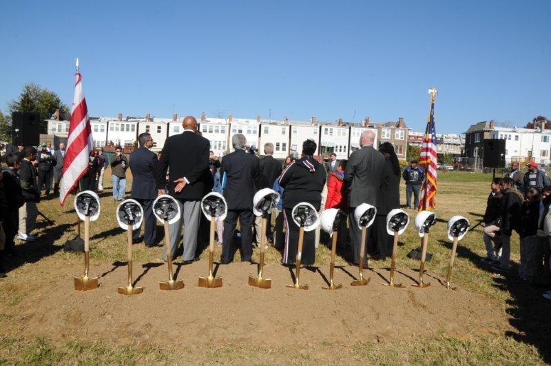 a crowd of people standing around several different types of objects