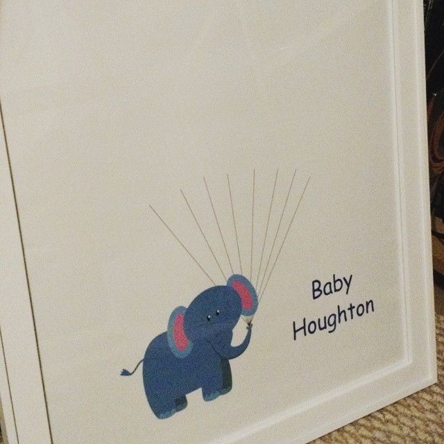 there is a po frame with a baby elephant holding balloons