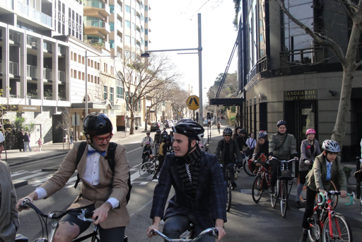many people are riding bicycles on a street