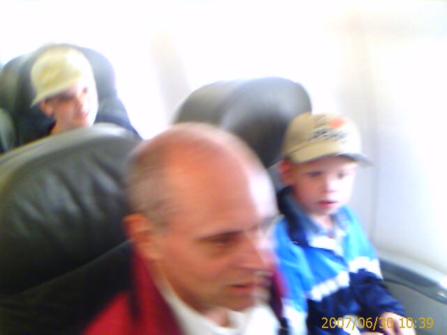 two s in an airplane with an older man