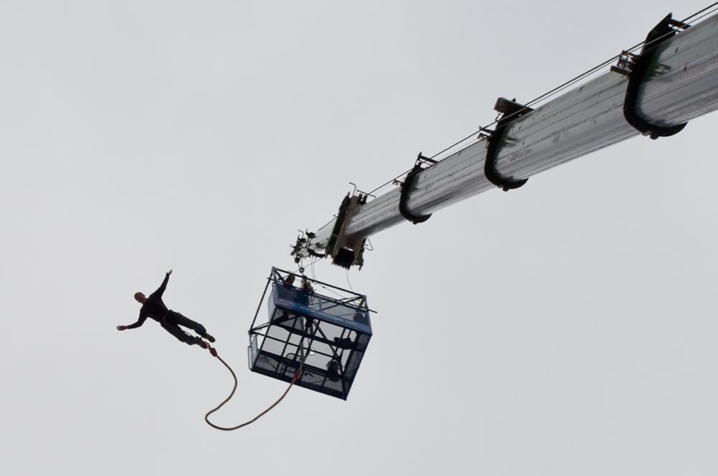 a man doing tricks on top of a skydiver