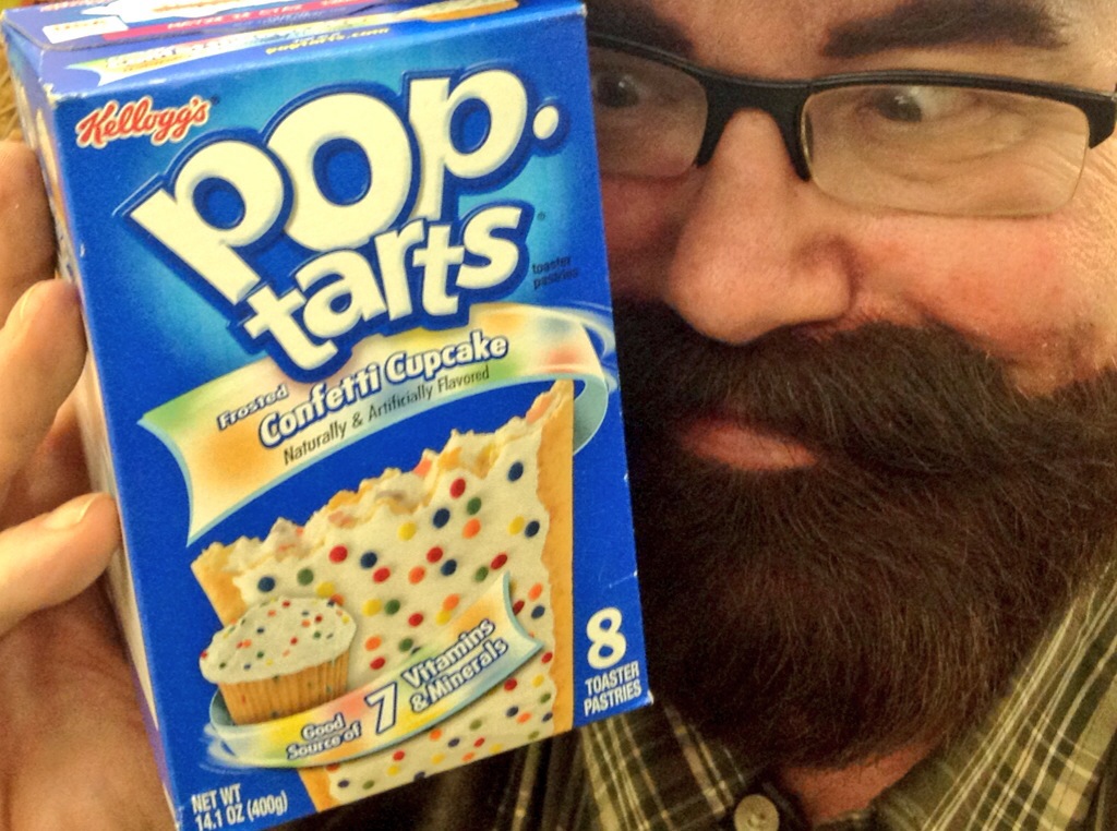 a man that is holding up a box of pop tarts