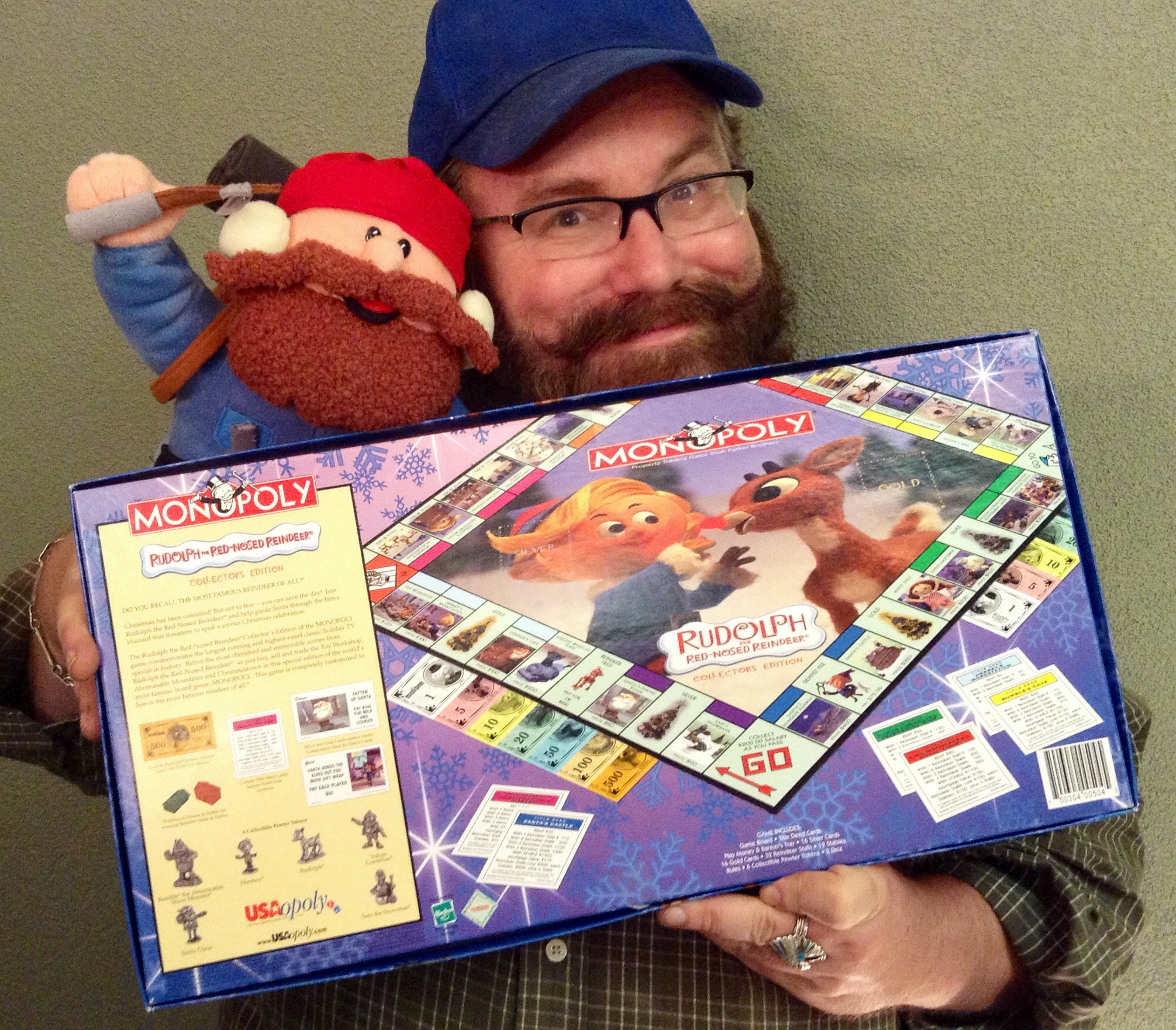 man holding up a board game for children