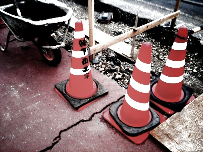 a dolly sits on the street with cones on it