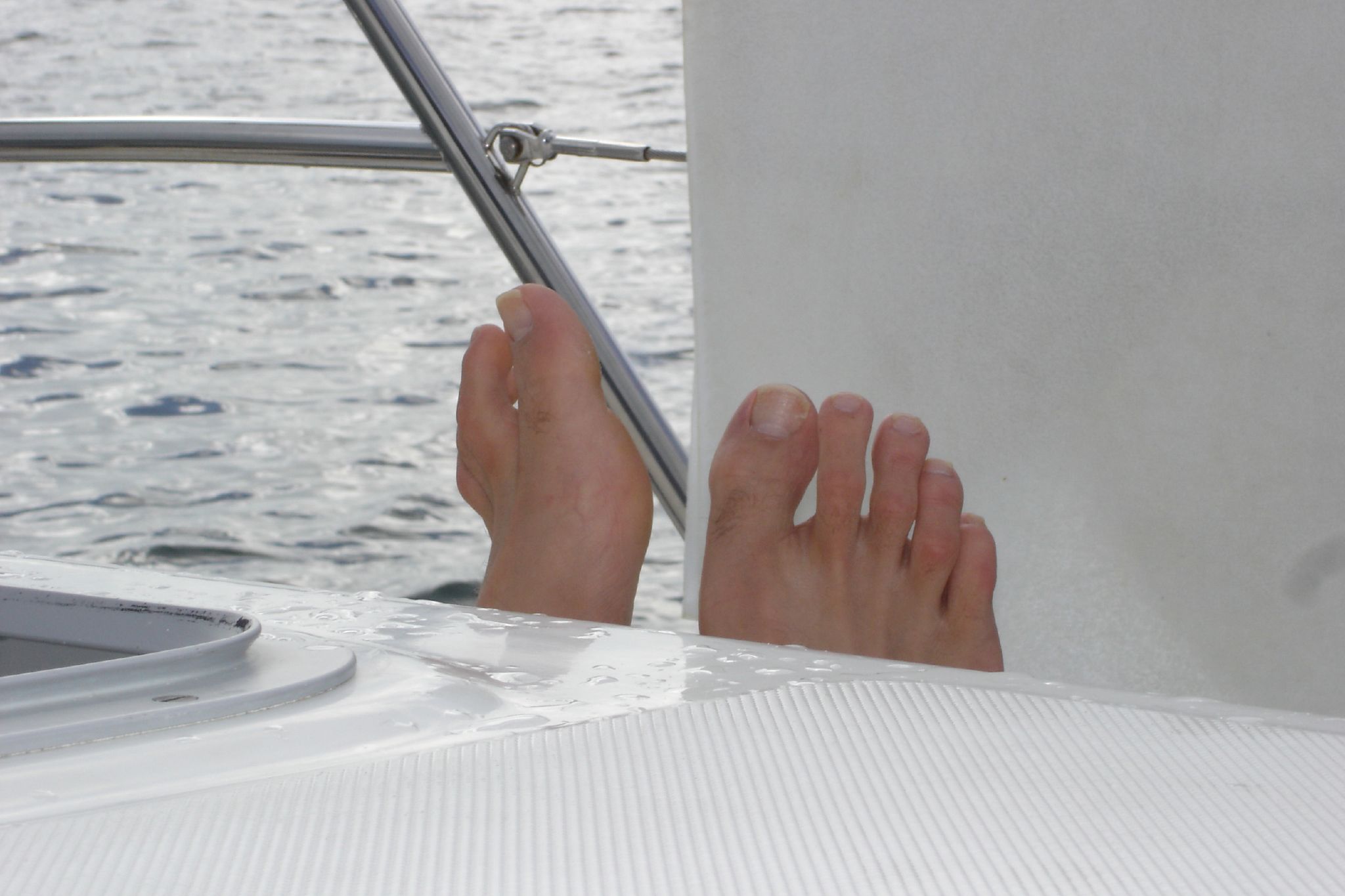 a person sitting at the front of a boat on the water