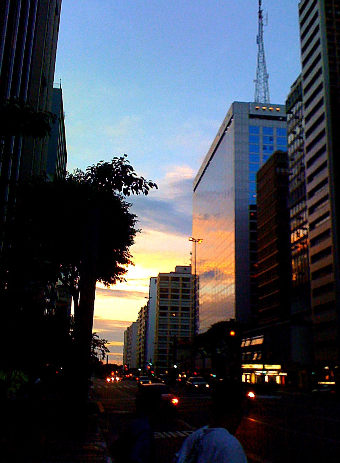 a large city street with tall buildings on both sides