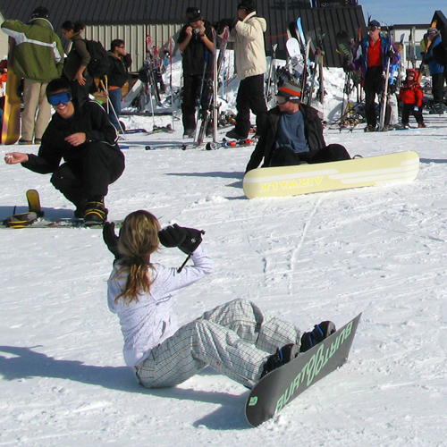 a woman on the snow with a snowboard