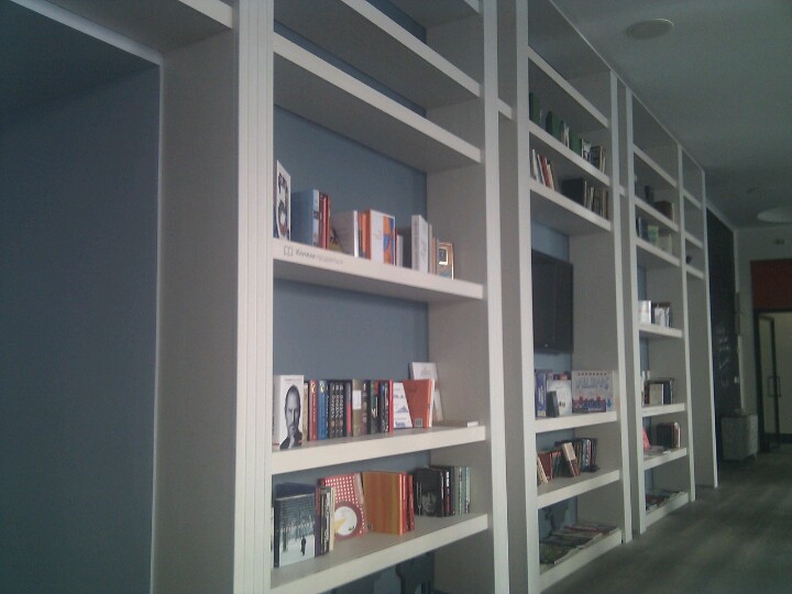 the bookshelves on the wall are neatly arranged