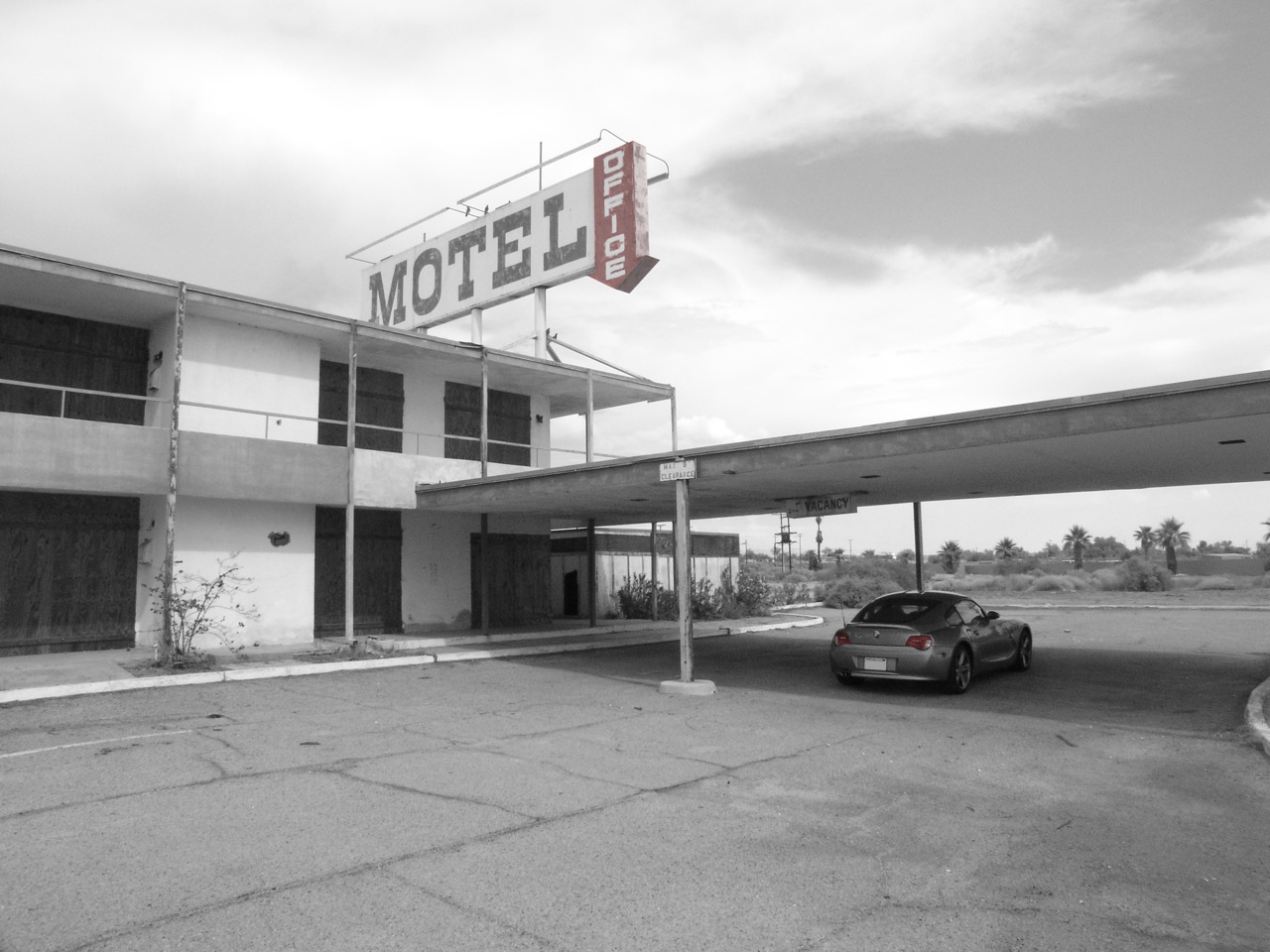 a motel sign is shown in a black and white po