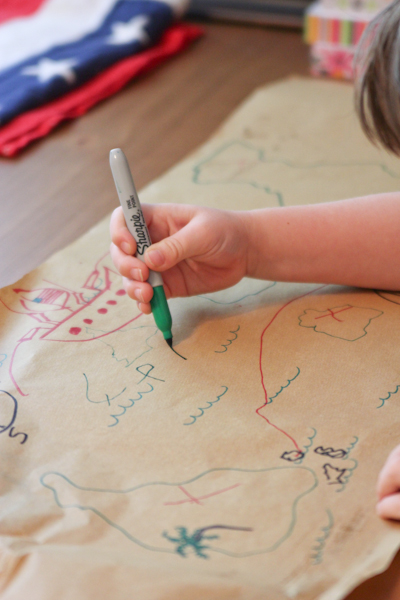 the child is playing with colored crayons