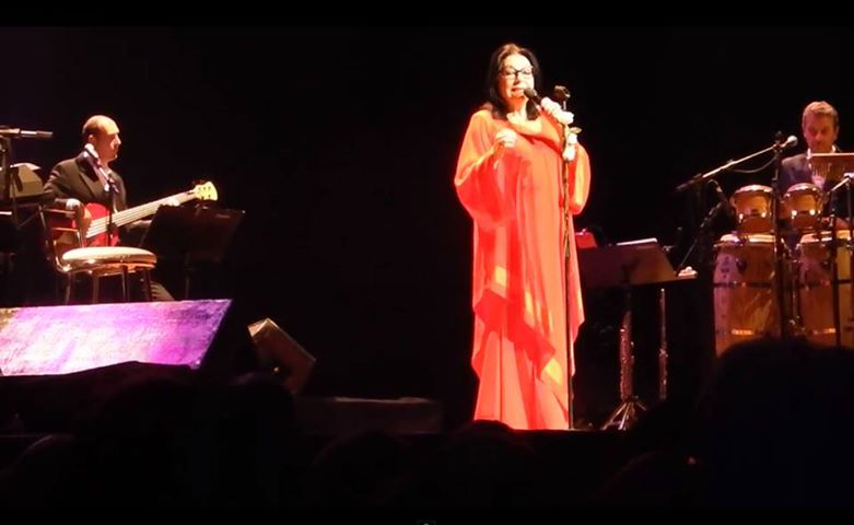 an image of a woman singing at a music concert