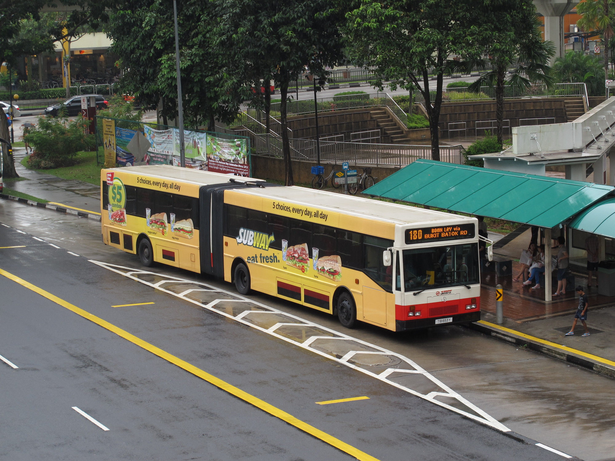 a bus stopped at a bus stop near the curb