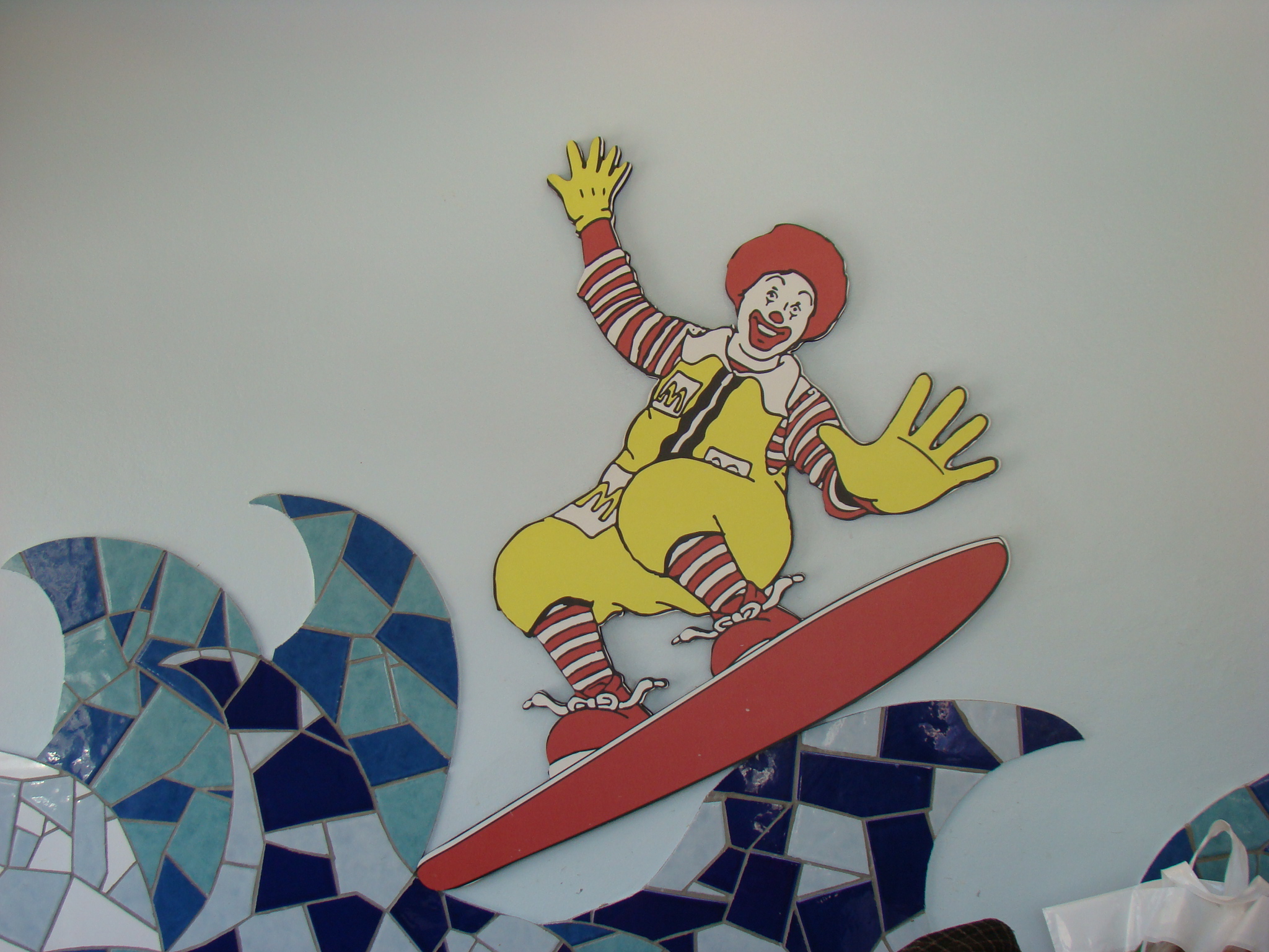 a man riding a skateboard while wearing a clown costume