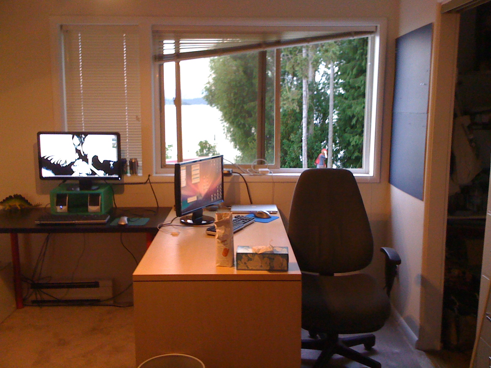 a computer desk with monitor, keyboard and monitor screen