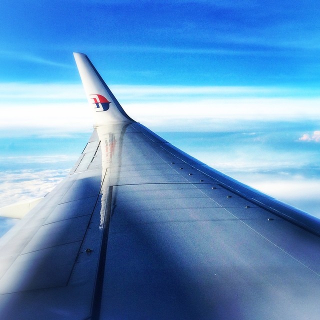 the wing of a commercial airplane flying in the air
