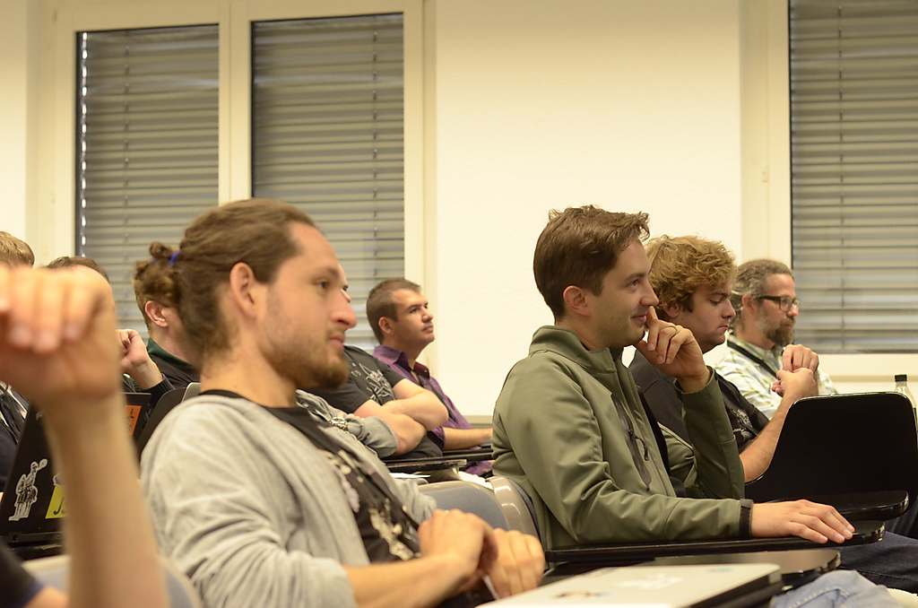 group of people in class room with laptops