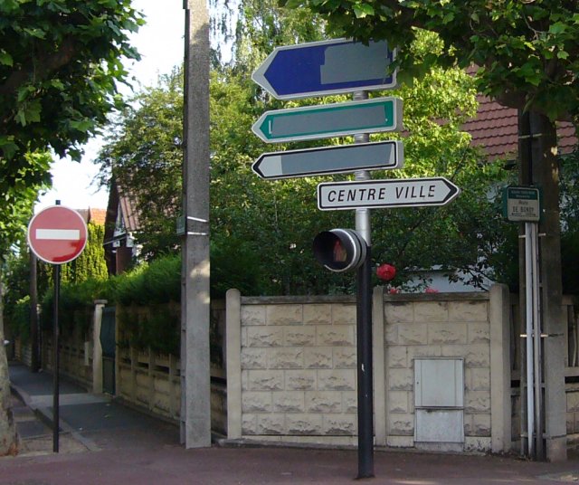 a street sign is displayed with some different signs