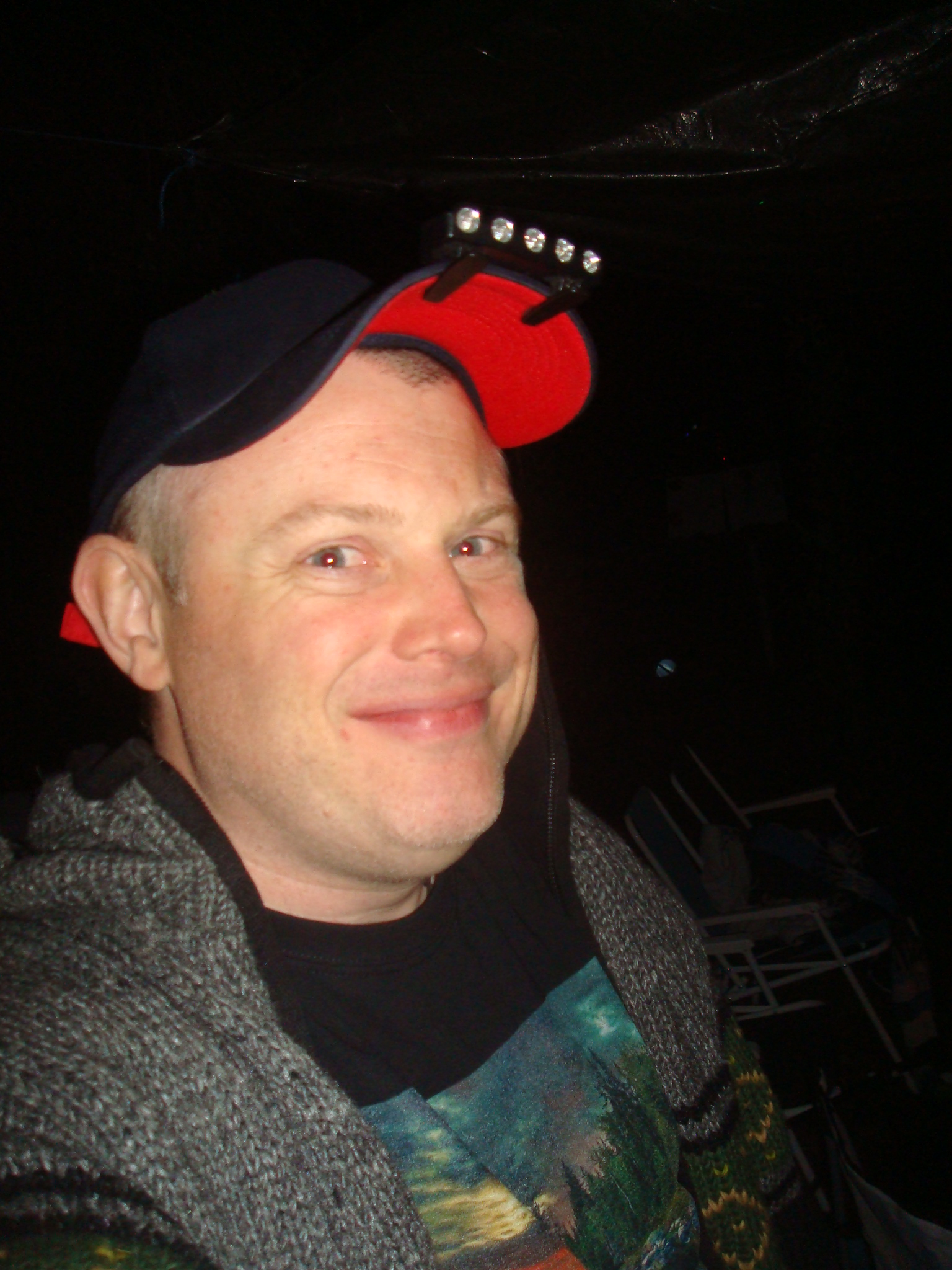 a man wearing a red hat with metal eyes