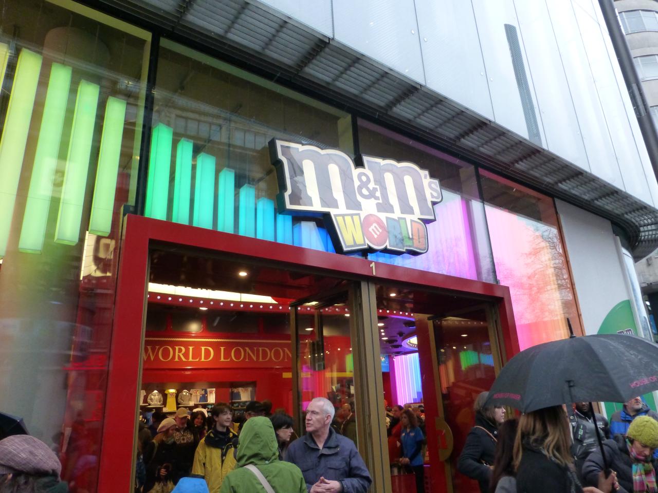 a crowd of people walking in front of a store